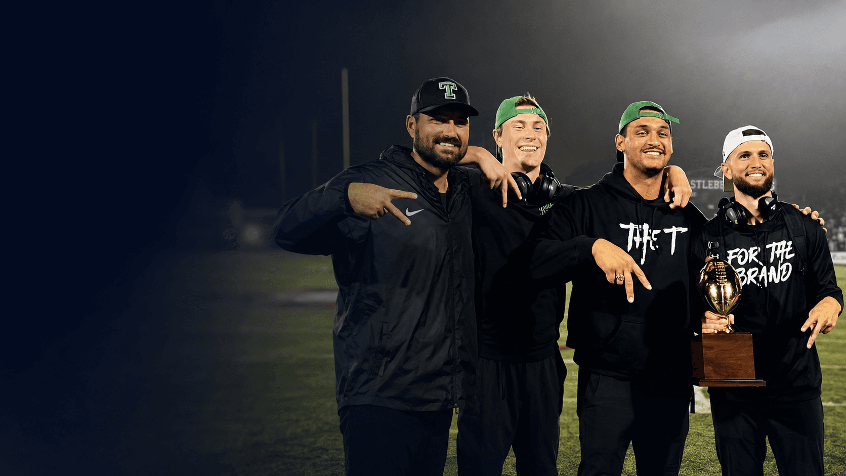 Tyler Henley with Tioga coaches celebrating high school playoff success.